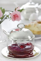 Jam jar with coaster and spoon